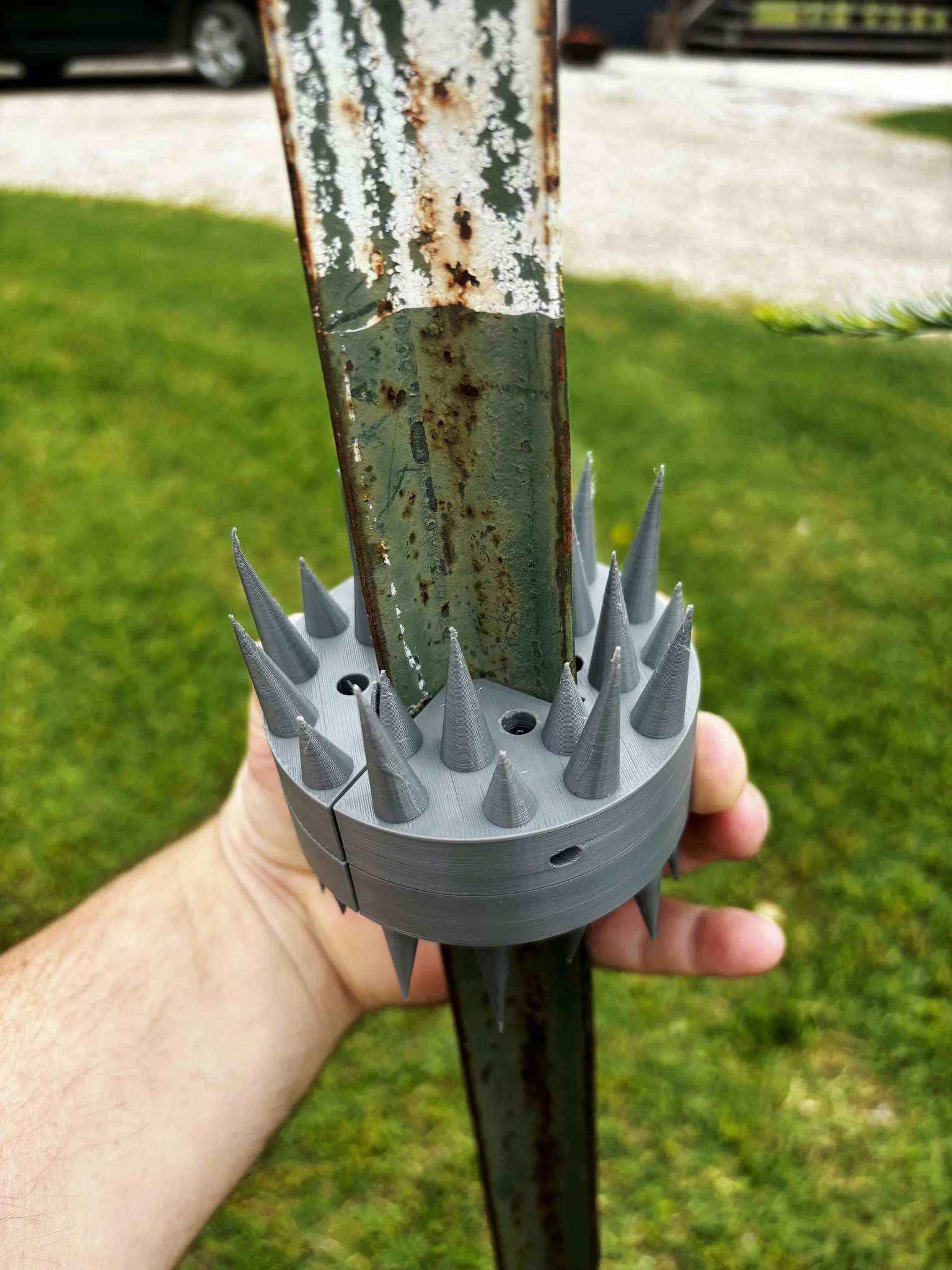 Installing Coon Claw by AirBoss raccoon deterrent on feeder pole