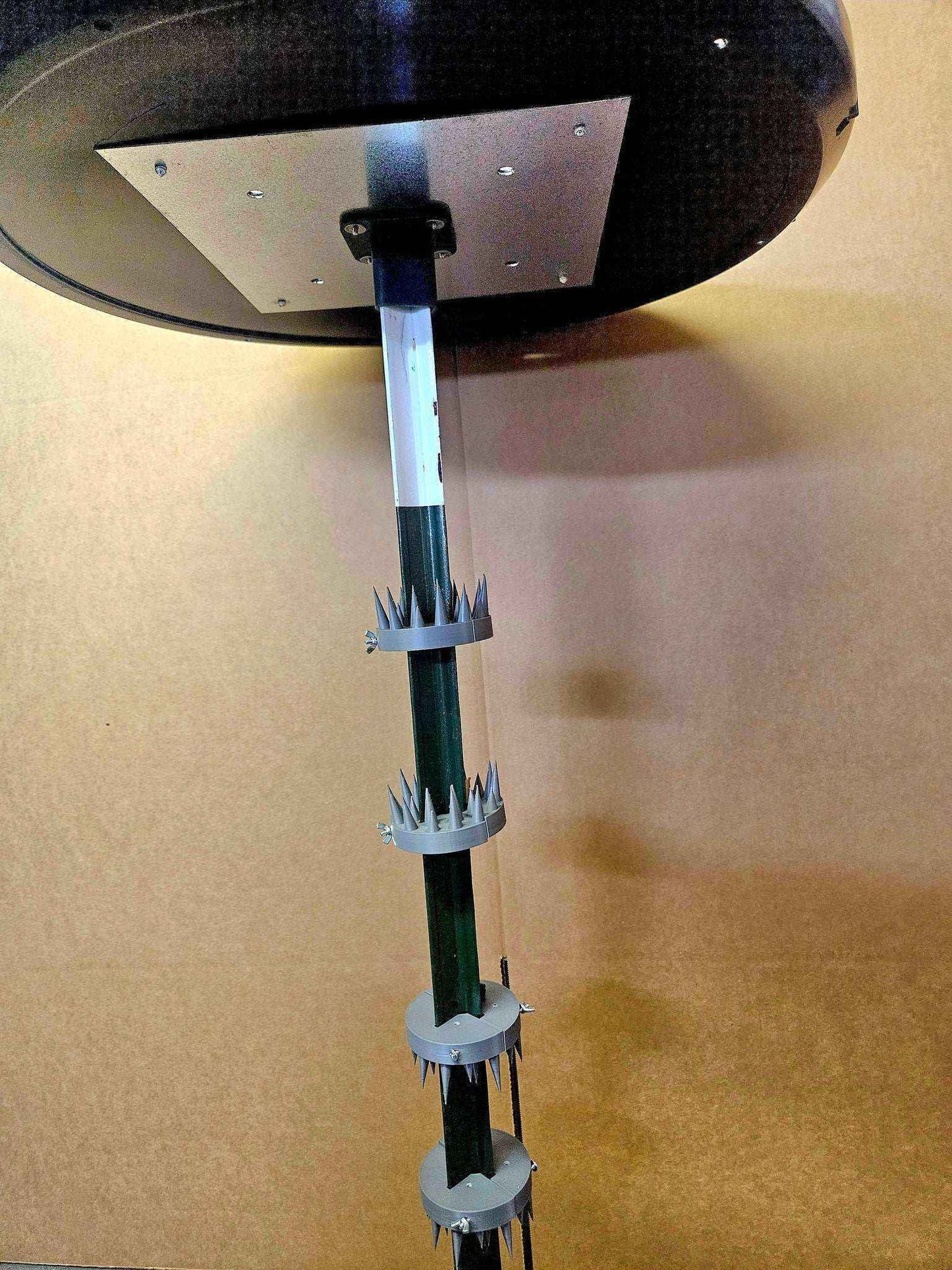 Coon Claw by AirBoss prevents raccoons from climbing up feeder pole