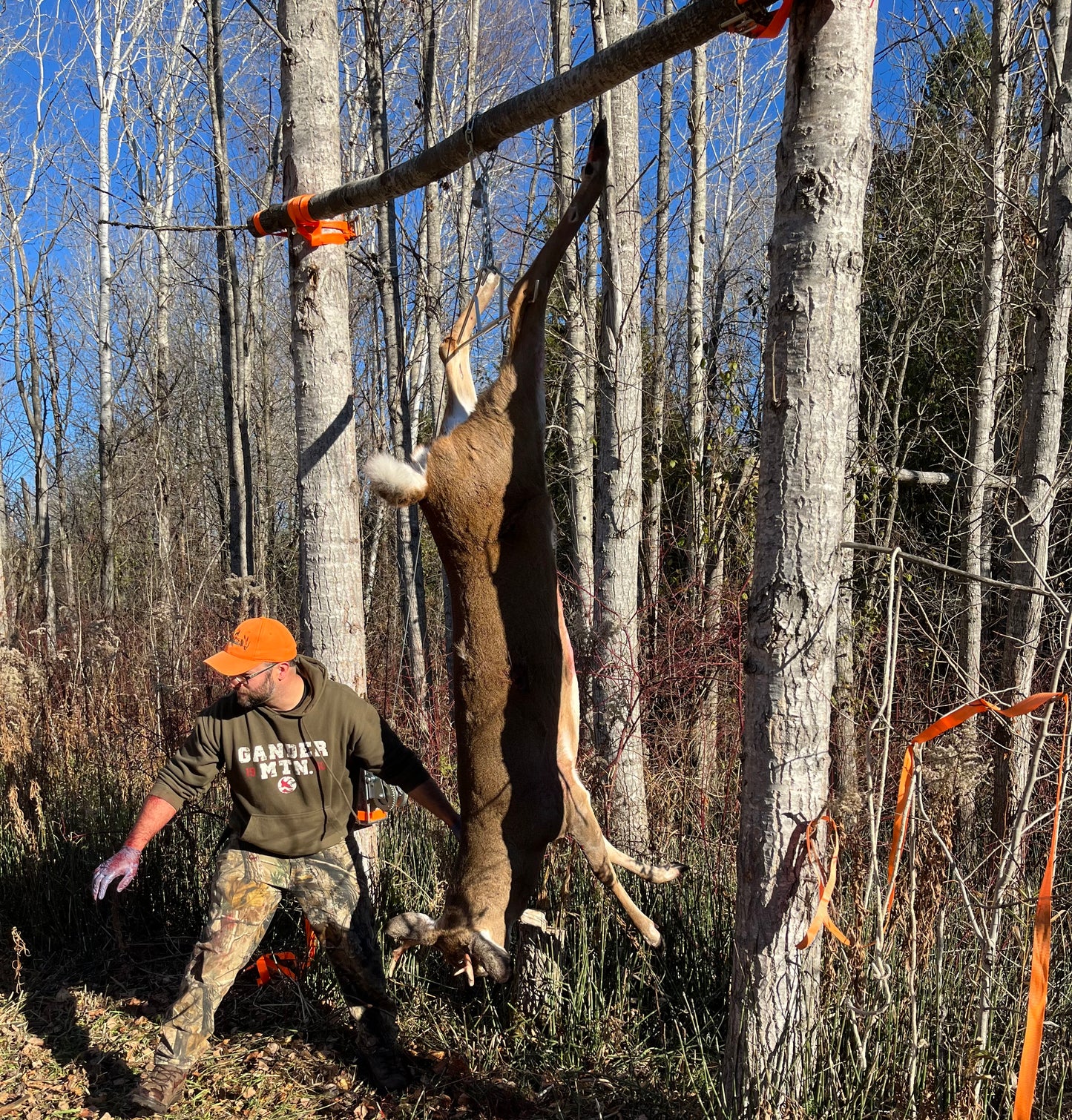 Hunter with harvested deer using CrankRup Hoist Kit