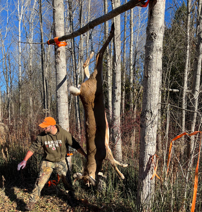 Hunter with harvested deer using CrankRup Hoist Kit